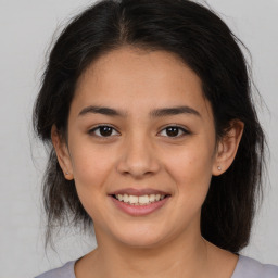 Joyful latino young-adult female with medium  brown hair and brown eyes