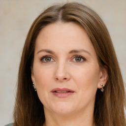 Joyful white adult female with long  brown hair and grey eyes