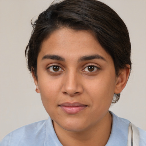 Joyful latino young-adult female with short  brown hair and brown eyes