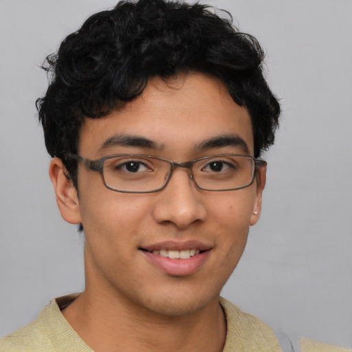 Joyful latino young-adult male with short  brown hair and brown eyes