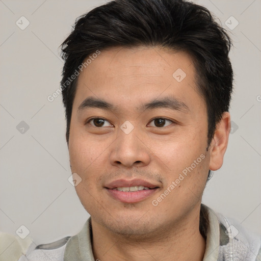 Joyful asian young-adult male with short  brown hair and brown eyes