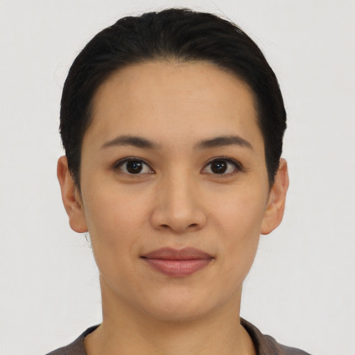 Joyful asian young-adult female with short  black hair and brown eyes