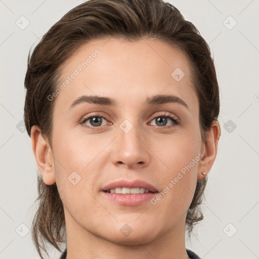 Joyful white young-adult female with medium  brown hair and grey eyes