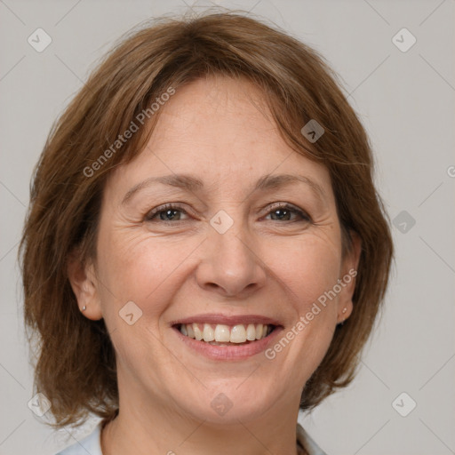 Joyful white adult female with medium  brown hair and brown eyes