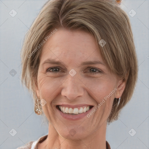 Joyful white adult female with medium  brown hair and grey eyes