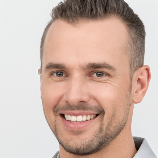 Joyful white adult male with short  brown hair and brown eyes