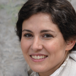 Joyful white adult female with medium  brown hair and brown eyes