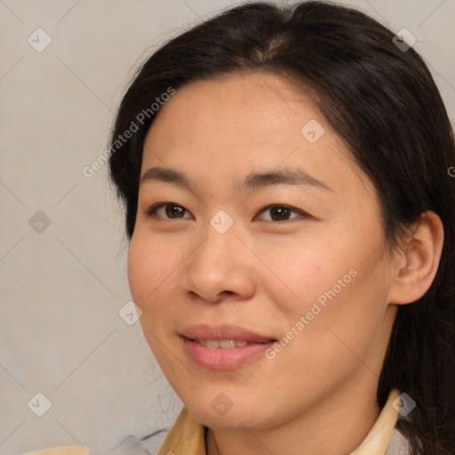 Joyful asian young-adult female with medium  brown hair and brown eyes