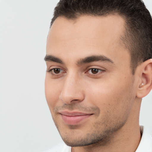 Joyful white young-adult male with short  brown hair and brown eyes