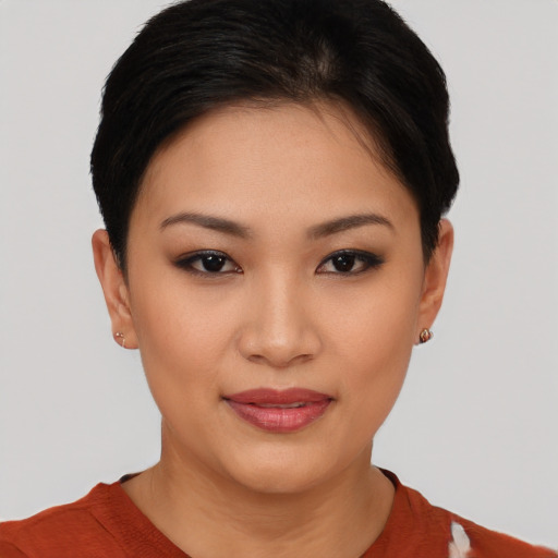 Joyful asian young-adult female with short  brown hair and brown eyes