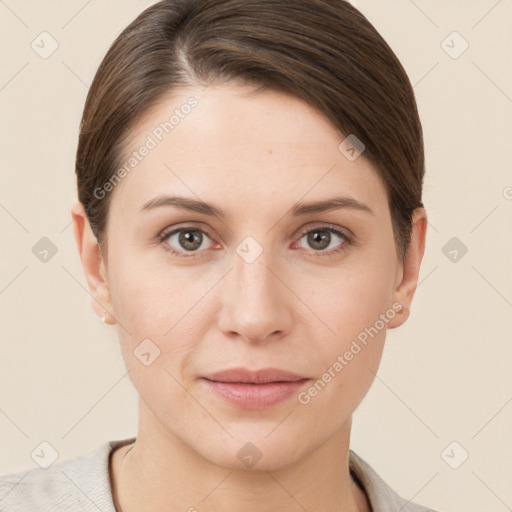 Joyful white young-adult female with short  brown hair and grey eyes