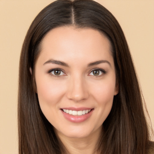 Joyful white young-adult female with long  brown hair and brown eyes