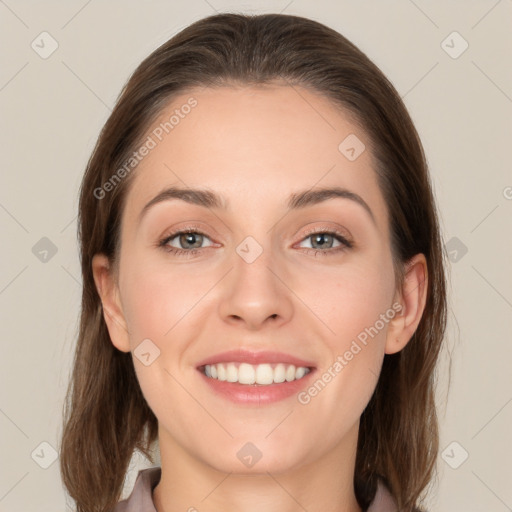 Joyful white young-adult female with long  brown hair and grey eyes