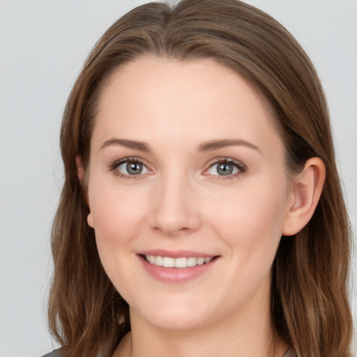 Joyful white young-adult female with long  brown hair and grey eyes