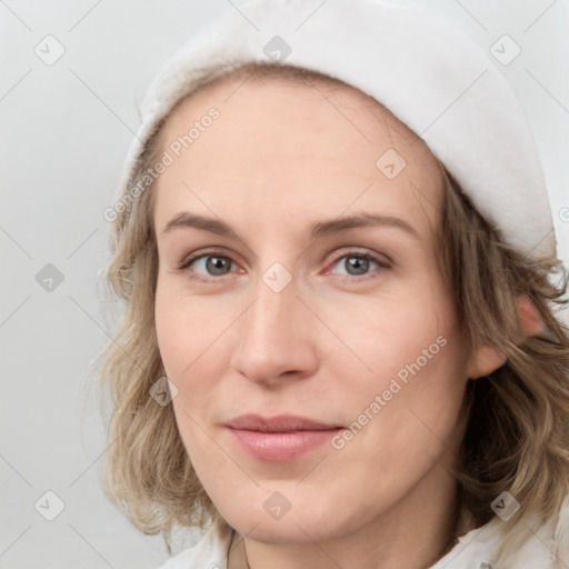 Joyful white young-adult female with medium  brown hair and blue eyes