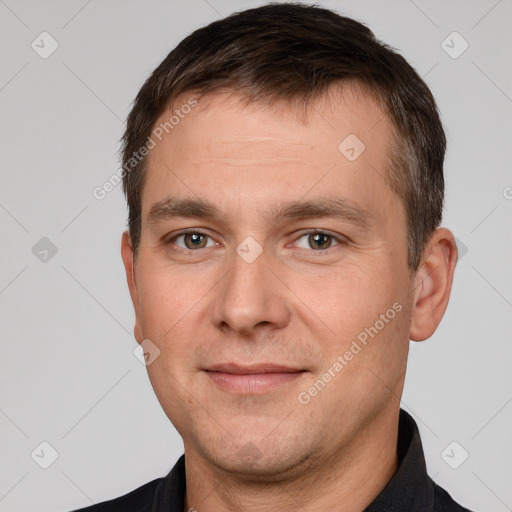 Joyful white adult male with short  brown hair and brown eyes