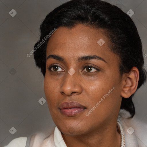 Joyful black young-adult female with short  brown hair and brown eyes