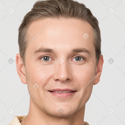 Joyful white young-adult male with short  brown hair and grey eyes