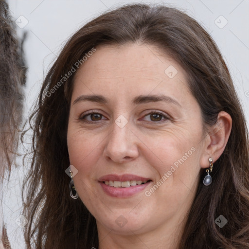 Joyful white adult female with long  brown hair and grey eyes