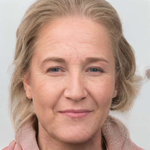 Joyful white adult female with medium  brown hair and blue eyes