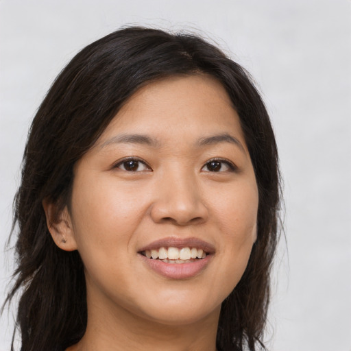 Joyful asian young-adult female with long  brown hair and brown eyes