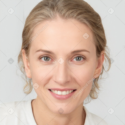 Joyful white young-adult female with medium  brown hair and blue eyes