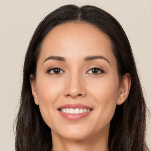 Joyful white young-adult female with long  brown hair and brown eyes