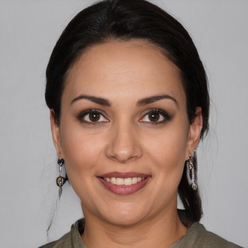 Joyful white young-adult female with medium  black hair and brown eyes