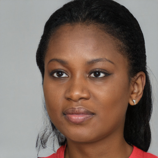Joyful black young-adult female with medium  black hair and brown eyes