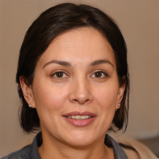 Joyful white adult female with medium  brown hair and brown eyes