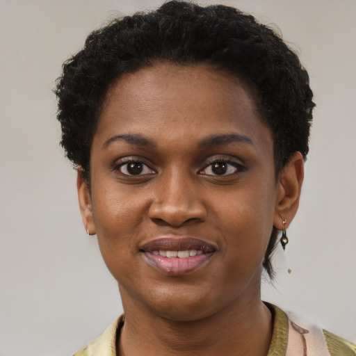 Joyful black young-adult female with short  brown hair and brown eyes