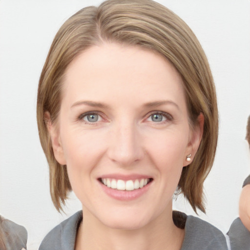 Joyful white young-adult female with medium  brown hair and blue eyes