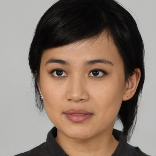 Joyful asian young-adult female with medium  black hair and brown eyes