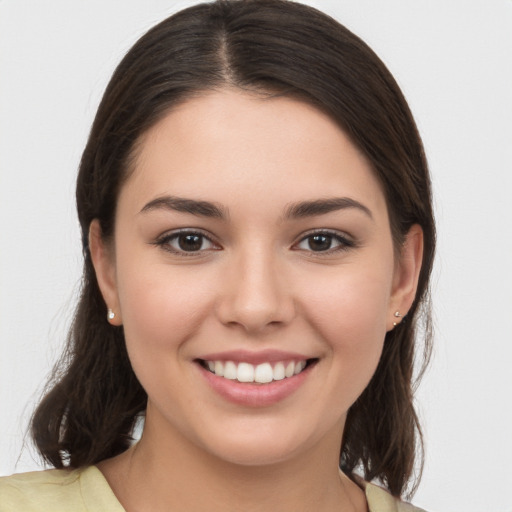 Joyful white young-adult female with medium  brown hair and brown eyes