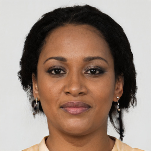 Joyful black adult female with medium  black hair and brown eyes