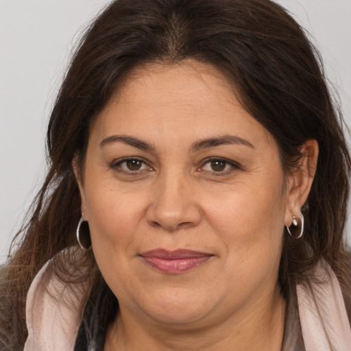 Joyful white adult female with medium  brown hair and brown eyes