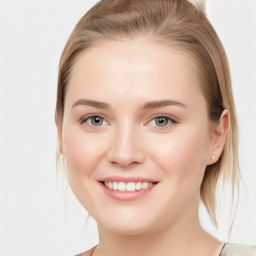 Joyful white young-adult female with medium  brown hair and blue eyes
