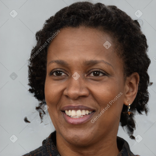 Joyful black young-adult female with medium  brown hair and brown eyes