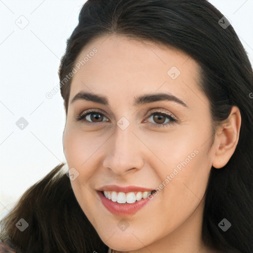 Joyful white young-adult female with long  brown hair and brown eyes