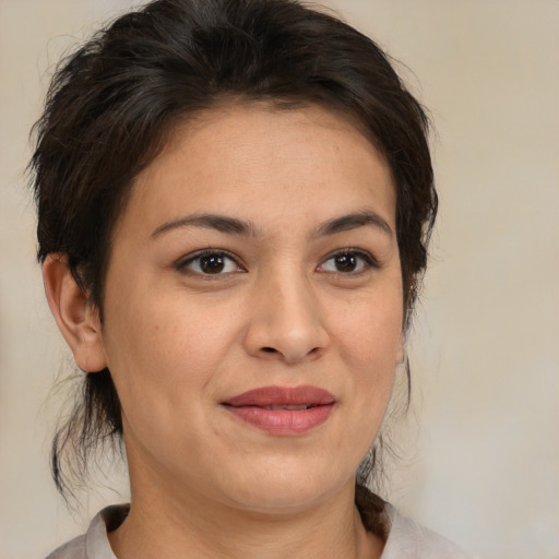 Joyful latino adult female with medium  brown hair and brown eyes