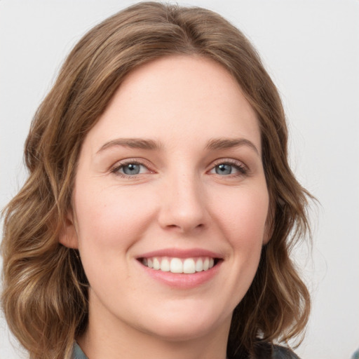 Joyful white young-adult female with long  brown hair and green eyes