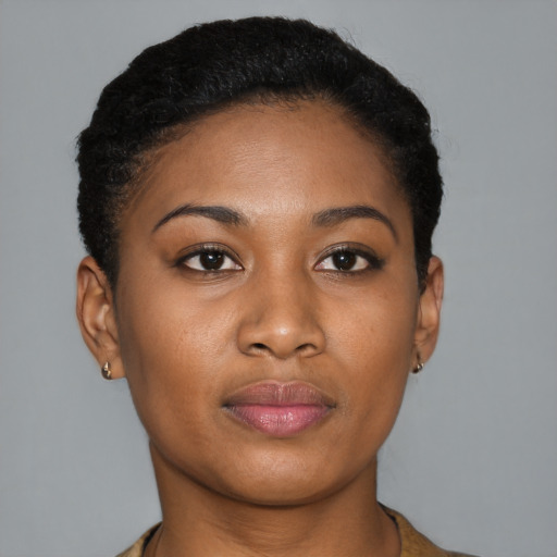 Joyful black young-adult female with short  black hair and brown eyes