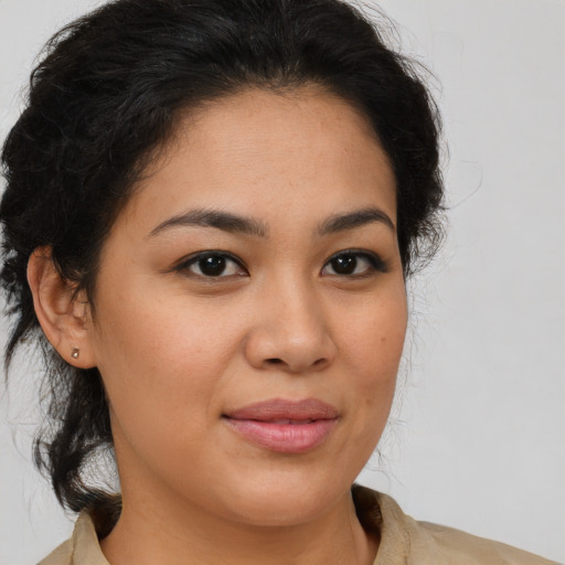 Joyful latino young-adult female with medium  brown hair and brown eyes