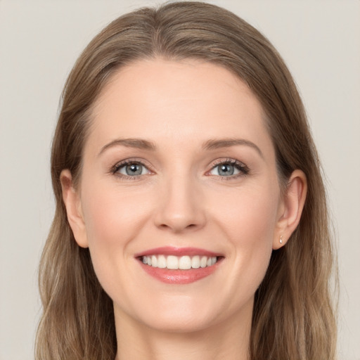 Joyful white young-adult female with long  brown hair and grey eyes