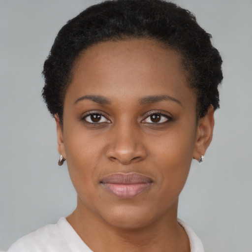 Joyful black young-adult female with short  brown hair and brown eyes