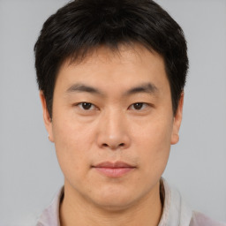 Neutral asian young-adult male with short  brown hair and brown eyes