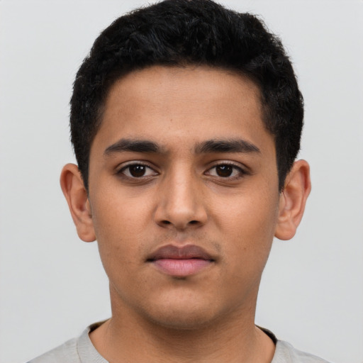 Neutral latino young-adult male with short  black hair and brown eyes