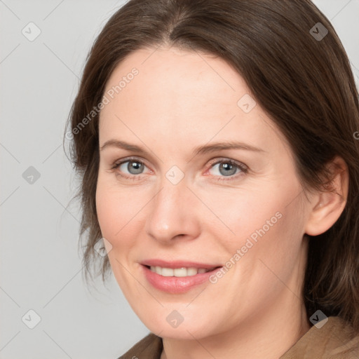 Joyful white adult female with medium  brown hair and brown eyes