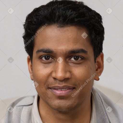 Joyful black young-adult male with short  black hair and brown eyes