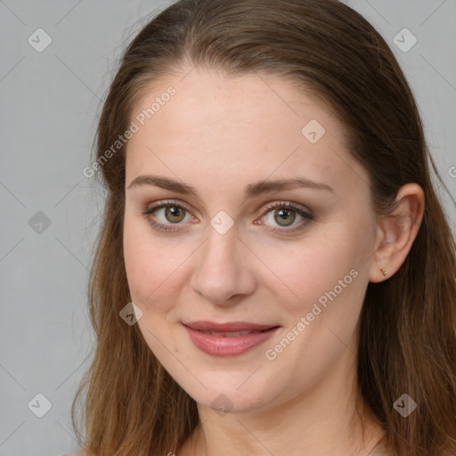 Joyful white young-adult female with long  brown hair and green eyes